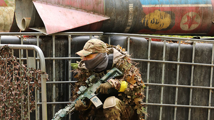 airsoft player crouching underneath rocket