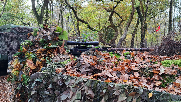 airsoft player hidden in ghillie suit